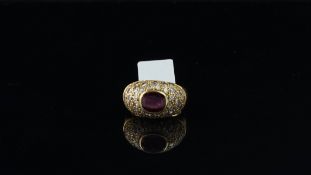 French ruby and diamond bombÃ© ring, central oval cut ruby surrounded by round brilliant cut