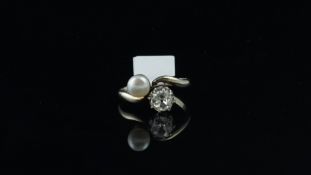 Pearl and diamond two stone twist ring, old mine cut diamond and 5.88mm white pearl, mounted in