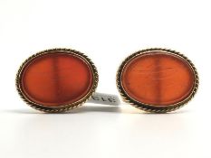 Pair of carved carnelian cufflinks, mounted in yellow metal tested as 18ct