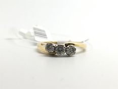 Three stone diamond ring, three round cut diamonds, in a twist design, set in 18ct yellow gold, ring