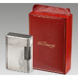 A Cased Silver-Plated Lighter, S. T. Dupont the rectangular body with engine-turned decoration 4,