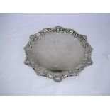 An Electroplate Salver the circular body with C-scroll-and-shell rim, centred with a vacant