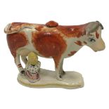 A Staffordshire Cow Creamer and Milkmaid, 19th Century,