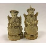 A Pair of Chinese Ivory Figures of A Seated Emperor and Empress,