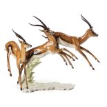 A Hutschenreuther Figure of Three Leaping Springbok, 20th Century,