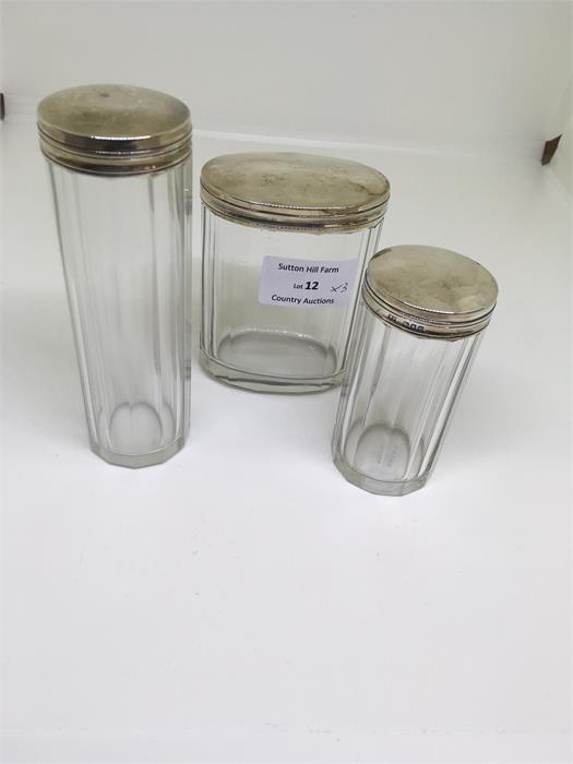 Three hallmarked silver top dressing table jars