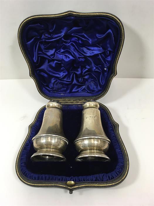 Pair of silver pepper pots in original box