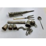 Collection of silver items includes silver thimbles needle posy flower holder stick pin etc