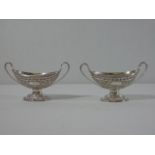 Pair of ornate silver salts each oval in shape with 2 handles on a pedestal base. Approx. 96g