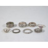 Collection of 8 assorted silver rings.