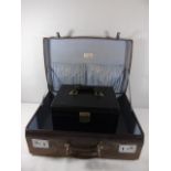 Vintage leather suitcase with a blue lining together with a leather vanity case