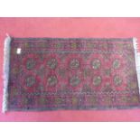 Small handmade Persian rug with fringed ends, red