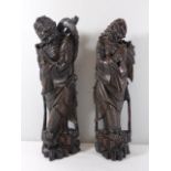 Pair of antique carved hardwood oriental figures with silver inlay and glass eyes approx 17" tall