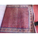 Persian handmade rug red background with blue and brown decoration, short tassel fringes approx 7' x