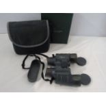 Pair of binoculars made by Bresser to include bag and lenses cap