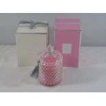 2 new and boxed fragranced candles - 1 pink and 1 white