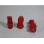 3 Carved oriental netsuke figures in coral red