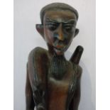 Large carved figure of a tribal man carrying his kill approx. 29" tall