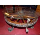 Wagon wheel design coffee table with glass top wrought iron feet approx. 29" dia 17.5" high