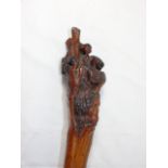 Hawthorn root walking stick with carved faces to the top