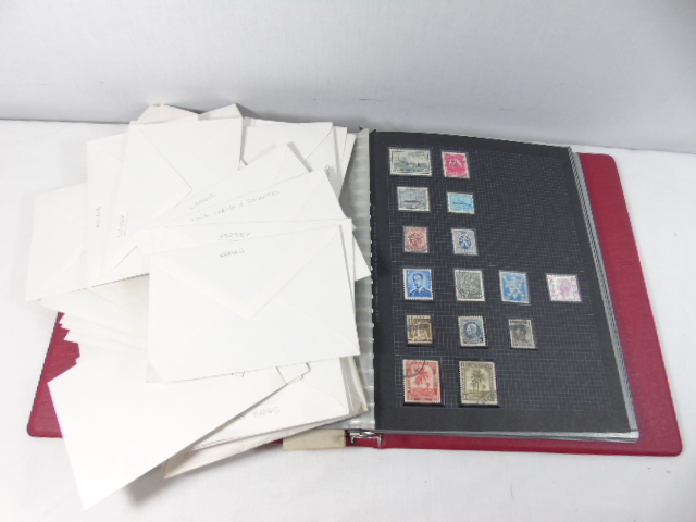 Stamp album loose stamps from around the world and framed bird cigarette cards