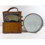 Wooden cased volt meter together with large brass mounted lens approx. 6" dia