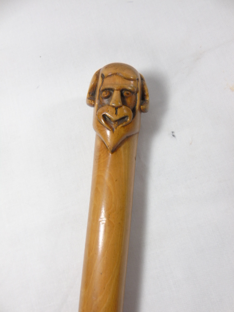 Carved hard wood cosh with a carved head top approx. 21.5" long