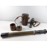 Leather cased drinking glass, leather cased monocular and a gun sight