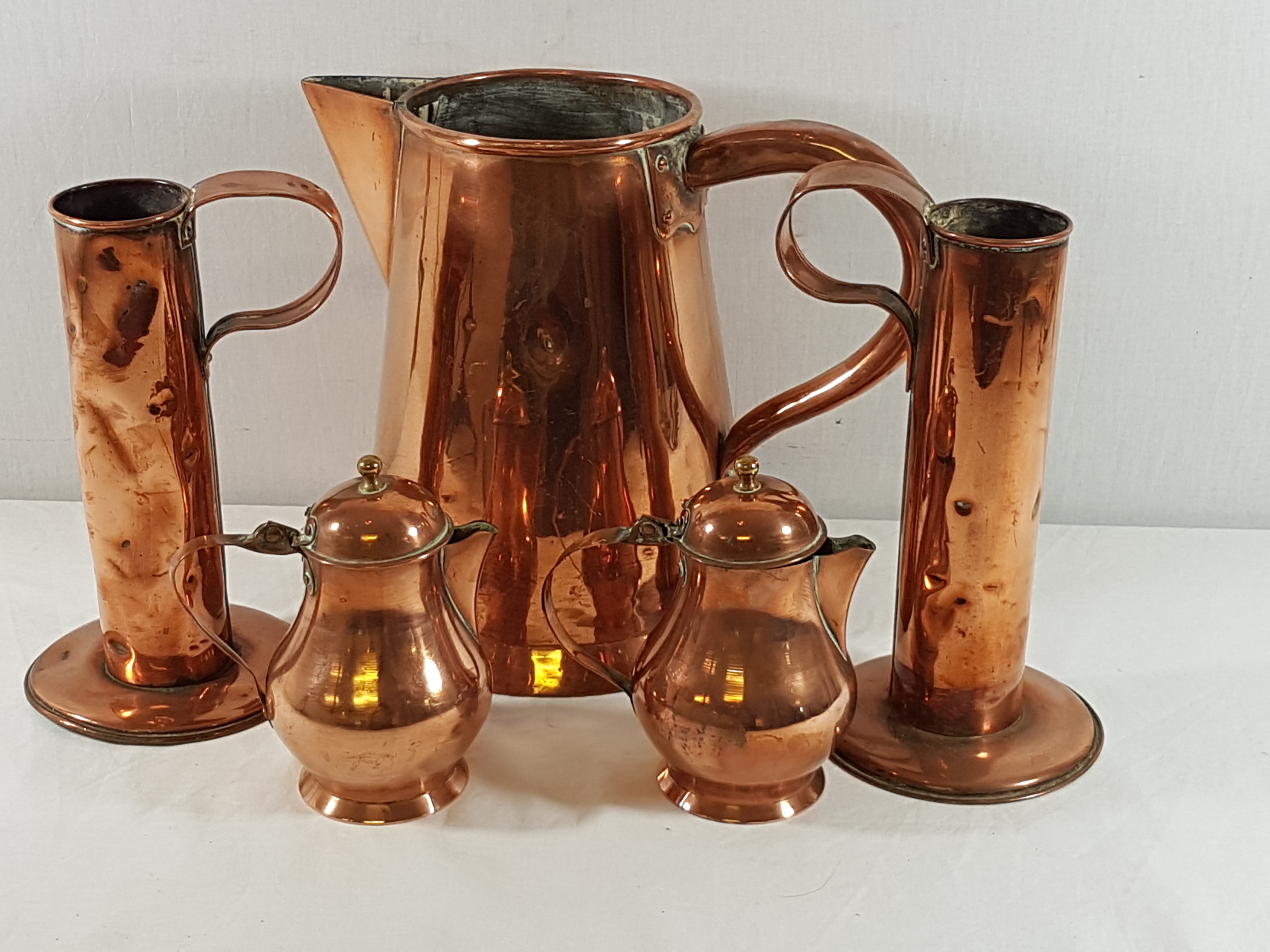 6 Various copper jugs, largest is 12'' tall and including a pair of art nouveau inspired examples