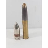 2 large artillary projectiles one with brass shell case