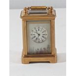 Miniture brass carriage clock with painted porcelain panels, complete with key, approx 2.5'' tall