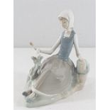 Lladro figure of a seated lady with a bird