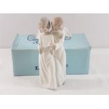 Lladro figure of a boy and girl as angels singing complete with box