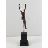 Cast bronze deco style dancing lady with carved bone face on marble plinth, approx 13'' tall