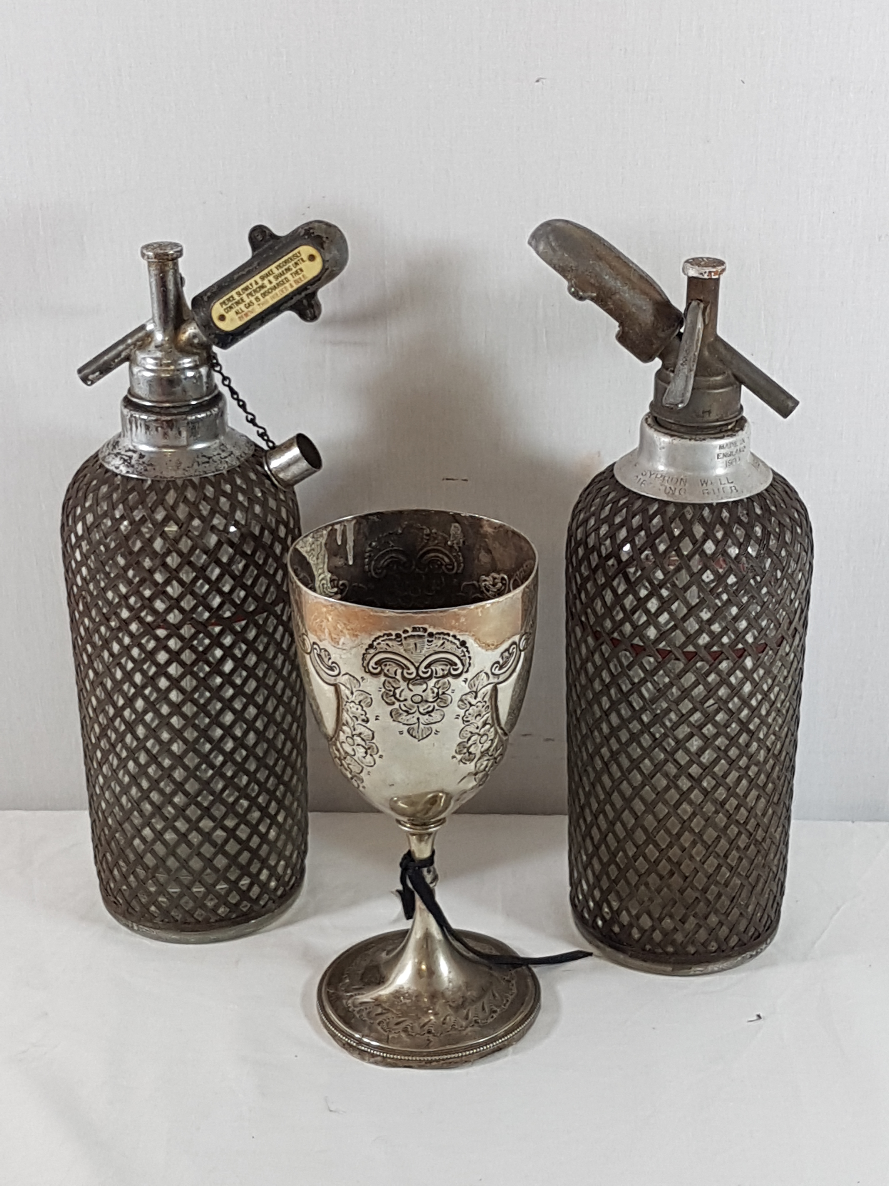 2 Vinatge soda syphons plus a silver plated goblet