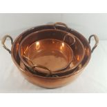 3 Graduated copper jam pans, largest 18'' diameter with brass handles, medium14'' diameter and