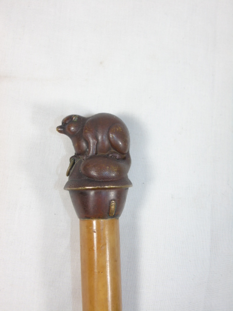 Cast metal topped walking stick in the form of a rodent type animal
