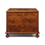 A George I burr walnut, crossbanded and featherbanded chest