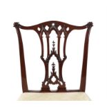 A set of six George III carved mahogany dining chairs
