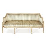 A large George III white painted and parcel-gilt three seater sofa in the manner of Gillows