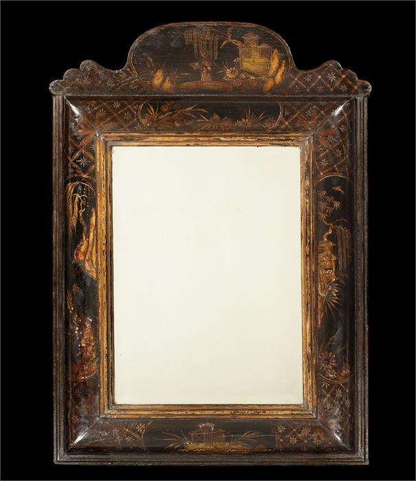 A late 17th century black japanned cushion frame mirror