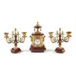 A small late 19th century red griotte marble and gilt brass timepiece garniture