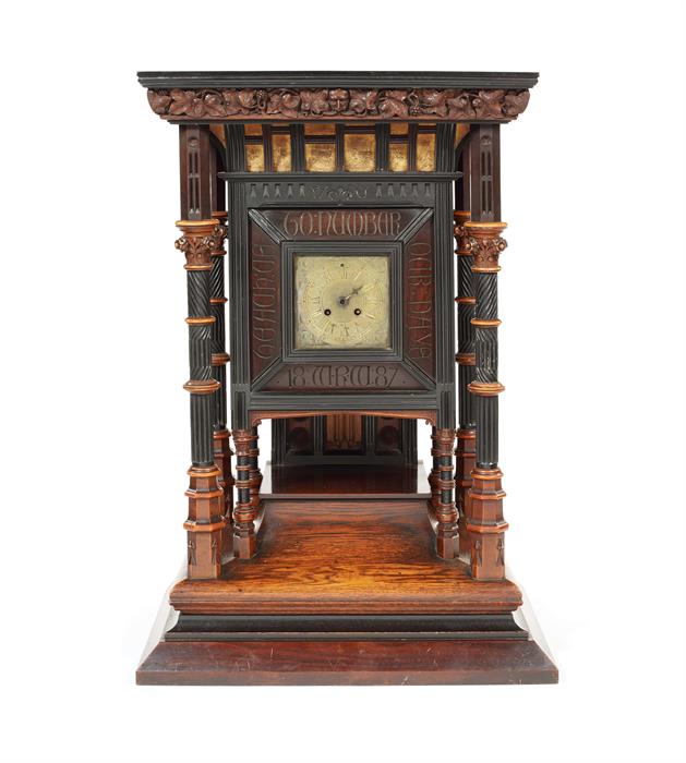 A large late 19thc oak, ebony, boxwood and parcel gilt mantel clock in the manner of Bruce Talbert