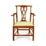 An unusual George III yew wood open armchair