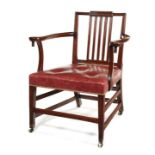 A large George III mahogany carved reading open armchair