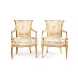 A pair of George III carved giltwood open armchairs attributed to B Harmer