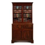 A George III carved mahogany secretaire bookcase attributed to Gillows