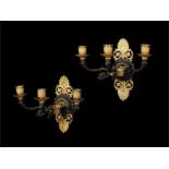 A pair of Empire gilt and patinated bronze three-light wall appliqués