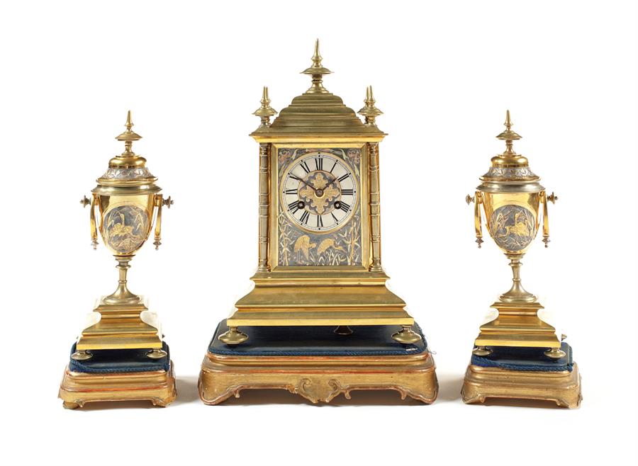 A late 19th century shakudo and gilt brass clock garniture