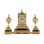 A late 19th century shakudo and gilt brass clock garniture